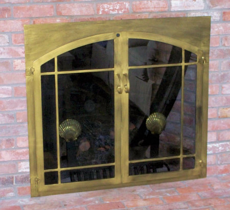 The Square to Arch Window-pane (straight top window- pane bar)  All (painted) antique brass finish, twin doors on stone, standard forged handles and smoked glass. Comes with slide mesh spark screen.